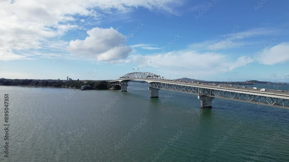 Auckland Harbour Bridge And North Shore Area On Waitemata Harbour In Auckland, New Zealand. aerial ascending shot Auckland Harbour Bridge And North Shore Area On Waitemata Harbour In Auckland, New Zealand. aerial ascending shot
