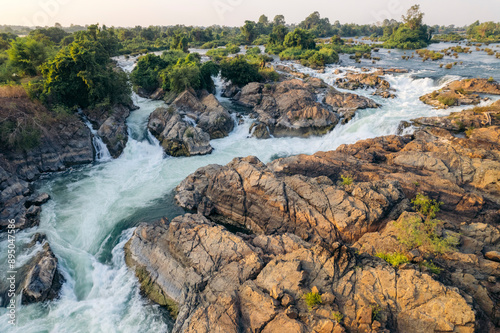 Beautiful Li Phi Somphamit Waterfalls with a rushing current around the rock and lush vegetation; Don Khon, Khon Tai, Laos photo