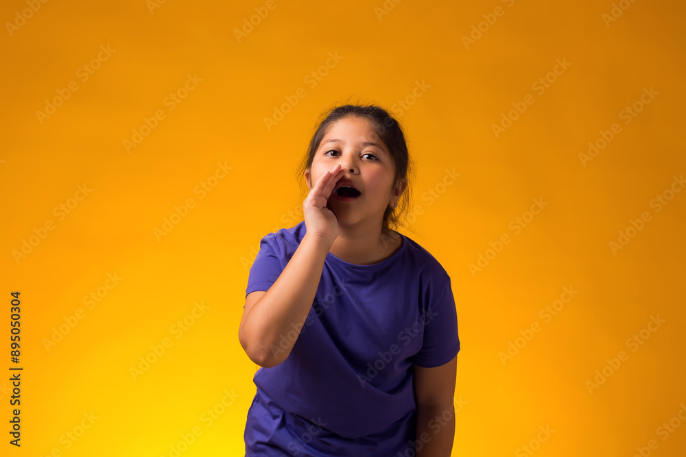 Child girl shouting and holding palm near opened mouth. Gossip and secret concept Child girl shouting and holding palm near opened mouth. Gossip and secret concept