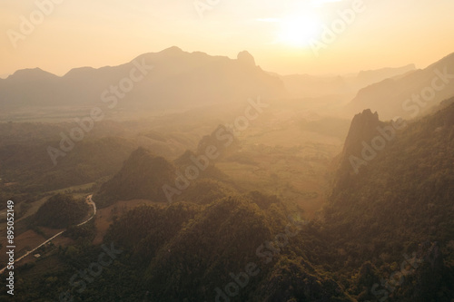 Karst formations in the warm sunset light in the Vang Vieng area of Laos; Vang Vieng, Vientiane Province, Laos photo