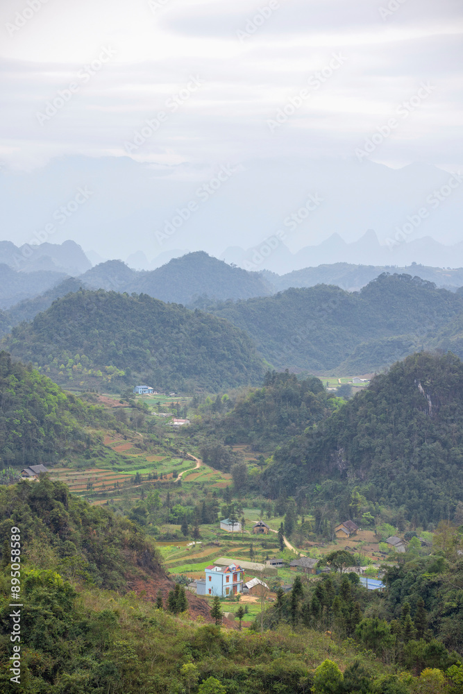 Mountainous landscape covered in lush vegetation, viewed from Tham Luong Cave, Ha Giang, Vietnam; Minh Tan, Vi Xuyen, Ha Giang, Vietnam Mountainous landscape covered in lush vegetation, viewed from Tham Luong Cave, Ha Giang, Vietnam; Minh Tan, Vi Xuyen, Ha Giang, Vietnam
