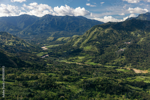 River winding through a lush mountainous landscape with the remote village of Lembah Ollon; Lumbah Ollon, Bonggakaradeng, Tana Toraja Regency, South Sulawesi, Indonesia photo