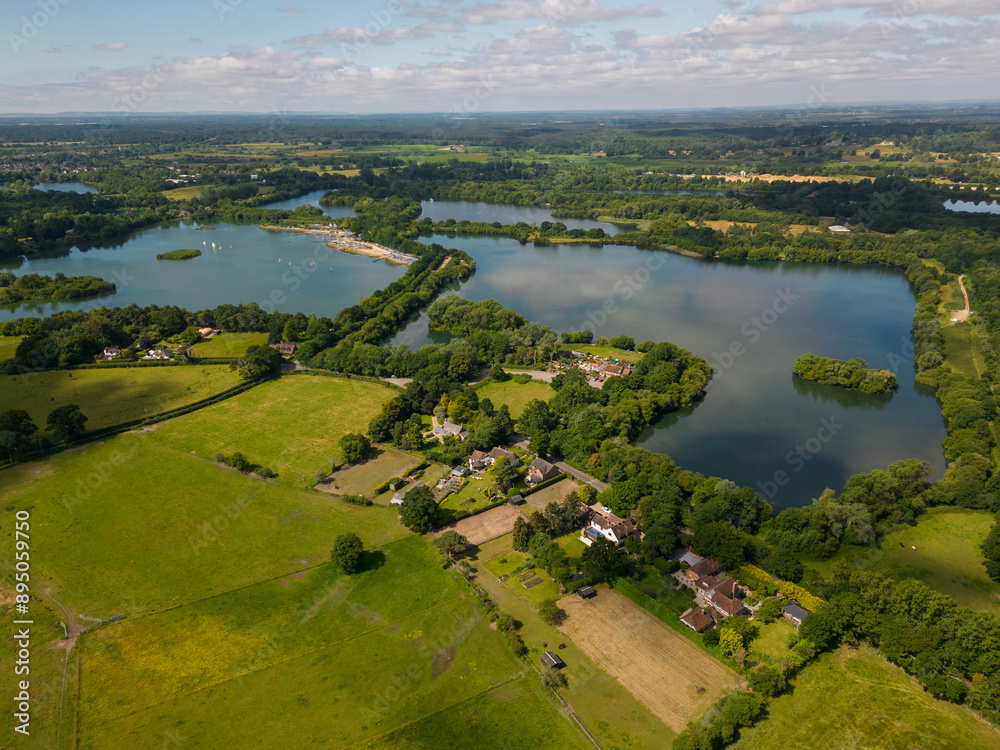 Panoramic view of Blashford Lakes Nature Reserve in New Forest UK. Recreational sailing on the lake near Ringwood. Beautiful English countryside and peaceful environment.
