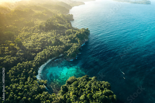 White sand beach along the vast coastline in warm sunlight, at Pantai Bakum, Central Sulawesi, Indonesia; Kendek, Banggai Islands Regency, Central Sulawesi, Indonesia photo