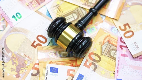Gavel on stack of euros spinning on table