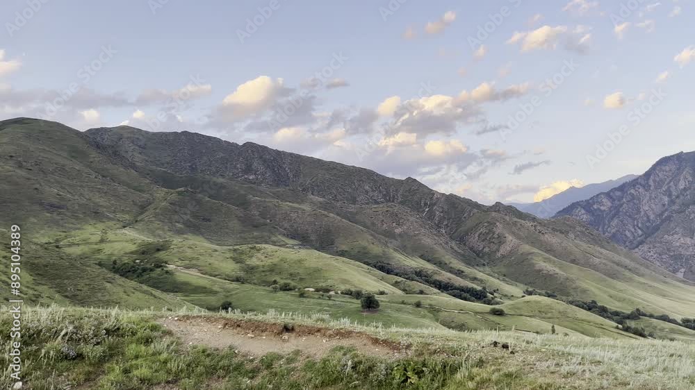 Breathtaking Scenic Aerial View of Verdant Rolling Hills and Majestic Mountains Under a Tranquil Cloud Dappled Sky During Golden Hour Breathtaking Scenic Aerial View of Verdant Rolling Hills and Majestic Mountains Under a Tranquil Cloud Dappled Sky During Golden Hour