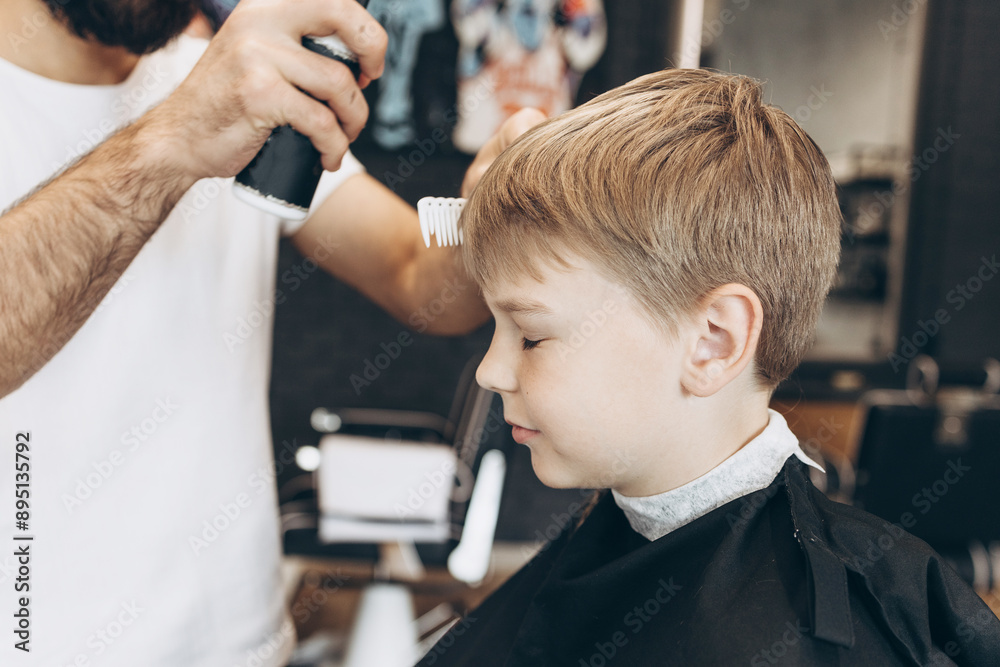 process of cutting a blond boy with a long braid in a chair in a barbershop salon, a barbershop concept for men and boys process of cutting a blond boy with a long braid in a chair in a barbershop salon, a barbershop concept for men and boys