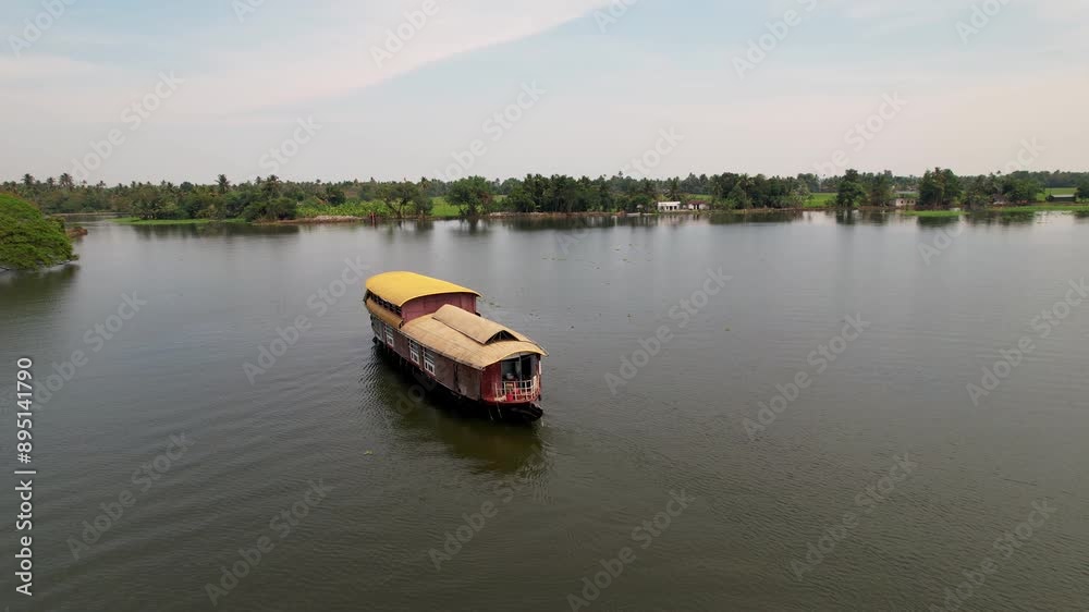 Houseboat cruises through the scenic Alleppey backwaters, passing by lush rice fields, showcasing the tranquil charm of Kerala. Travel, Vacation. Houseboat cruises through the scenic Alleppey backwaters, passing by lush rice fields, showcasing the tranquil charm of Kerala. Travel, Vacation.