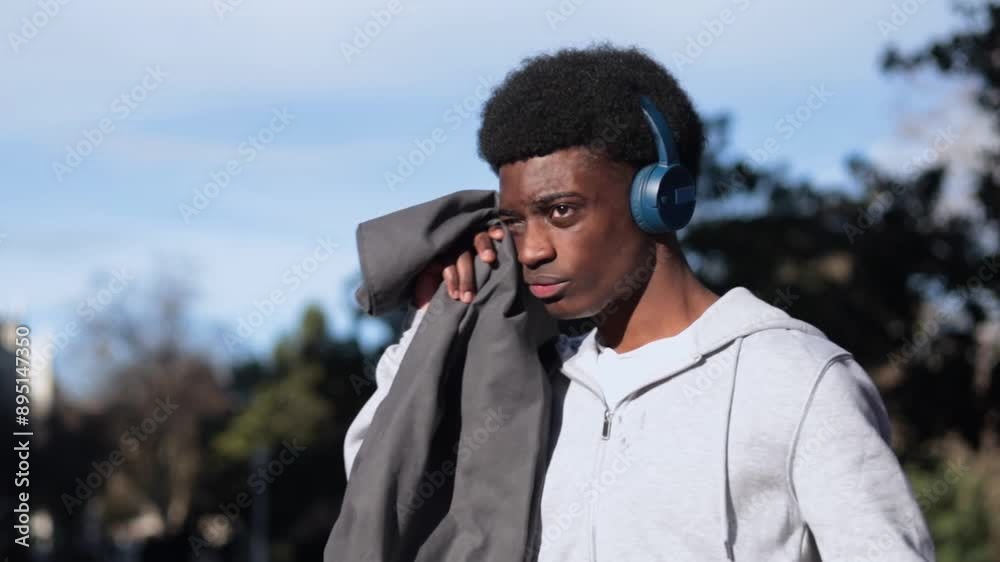 Tired african man after jogging using a sweat towel after exercising. Tired african man after jogging using a sweat towel after exercising.