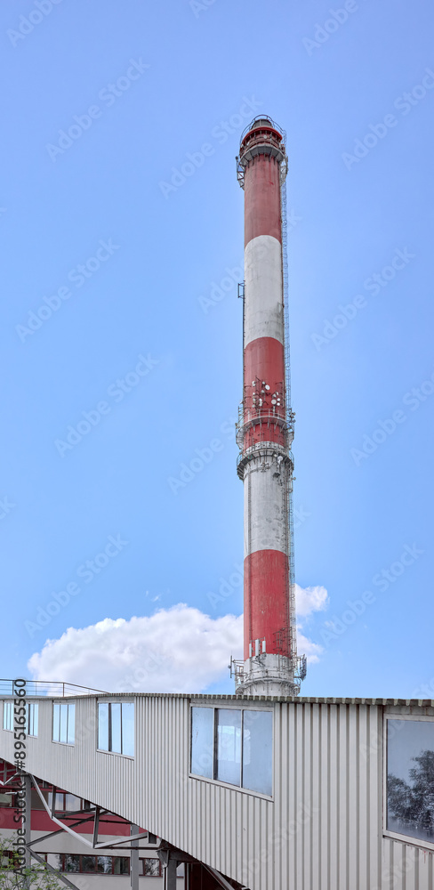 The chimney of a coal-fired power plant against the sky. The chimney of a coal-fired power plant against the sky.