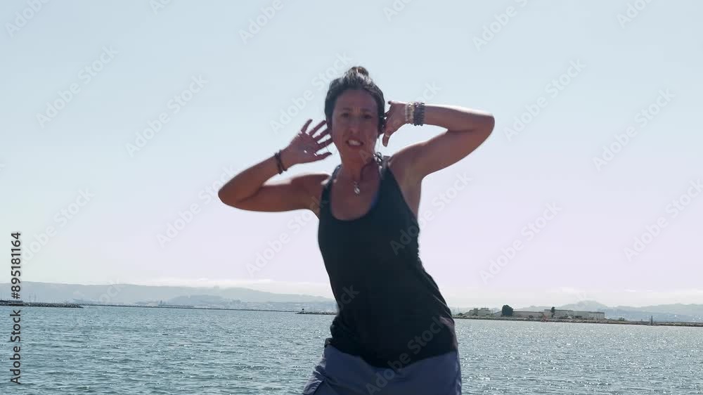 A Latina dancer embraces the pier’s ambiance, delivering smooth, expressive choreography with emotion.