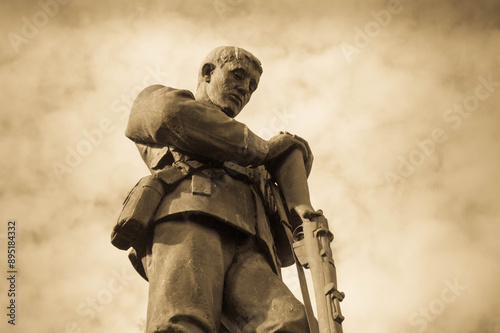 Old statue of a World War One and Two soldier at memorial or monument in Lancashire, UK photo