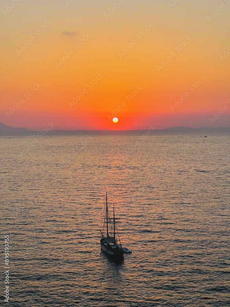 Boat sailing towards the horizon at sunset. Boat sailing towards the horizon at sunset.