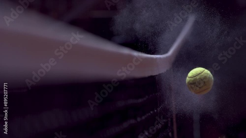 slow motion shot of a tennis ball hitting the net photo