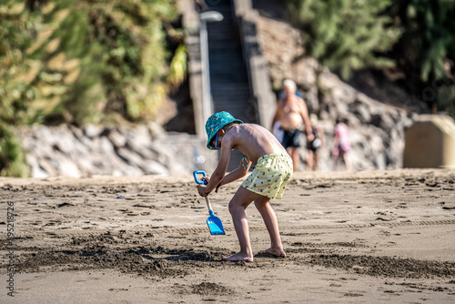 niño jugando en la playa del ingez,maspalomas,gran canarias photo