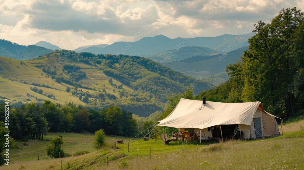 A Spacious Canvas Tent Is Set up on a Picturesque Hilltop, Offering Stunning Views of Majestic Mountains During the Day A Spacious Canvas Tent Is Set up on a Picturesque Hilltop, Offering Stunning Views of Majestic Mountains During the Day
