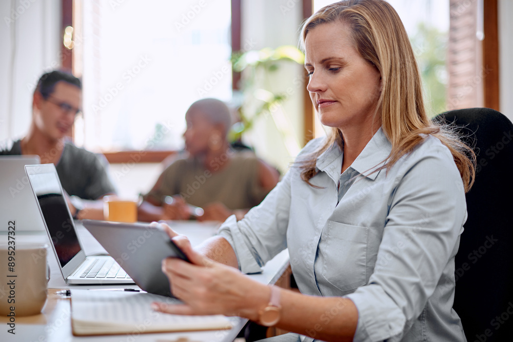 Business, mature woman and tablet with research at desk for creative project, checking email and typing review. Professional, employee and digital app for company website feedback in coworking office Business, mature woman and tablet with research at desk for creative project, checking email and typing review. Professional, employee and digital app for company website feedback in coworking office