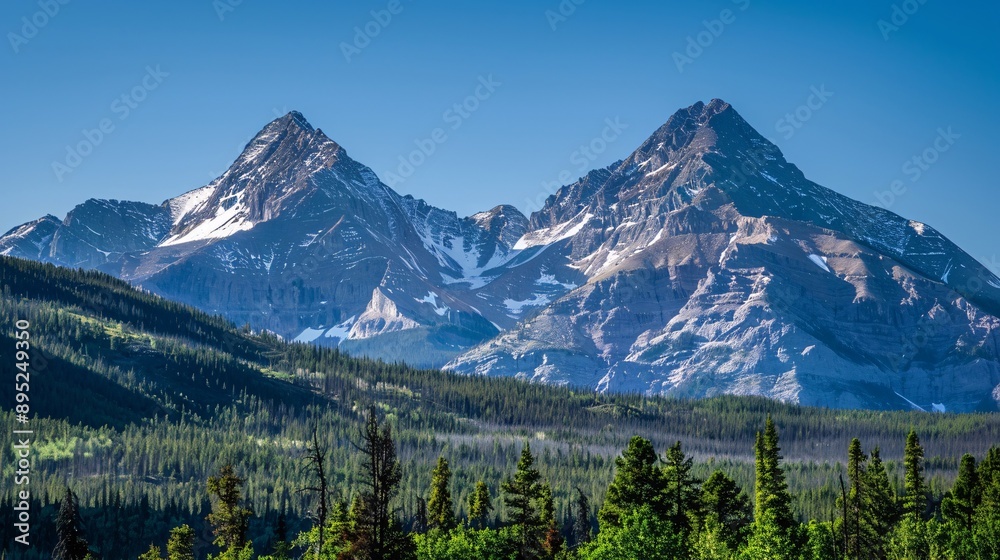 Obraz premium The rugged peaks of mountains rising above the treeline, their slopes covered in a patchwork of forest and bare rock, showcasing the grandeur of nature.