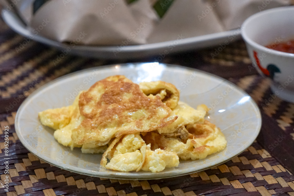 Wrapped nasi lemak and egg omelette in a plate Wrapped nasi lemak and egg omelette in a plate