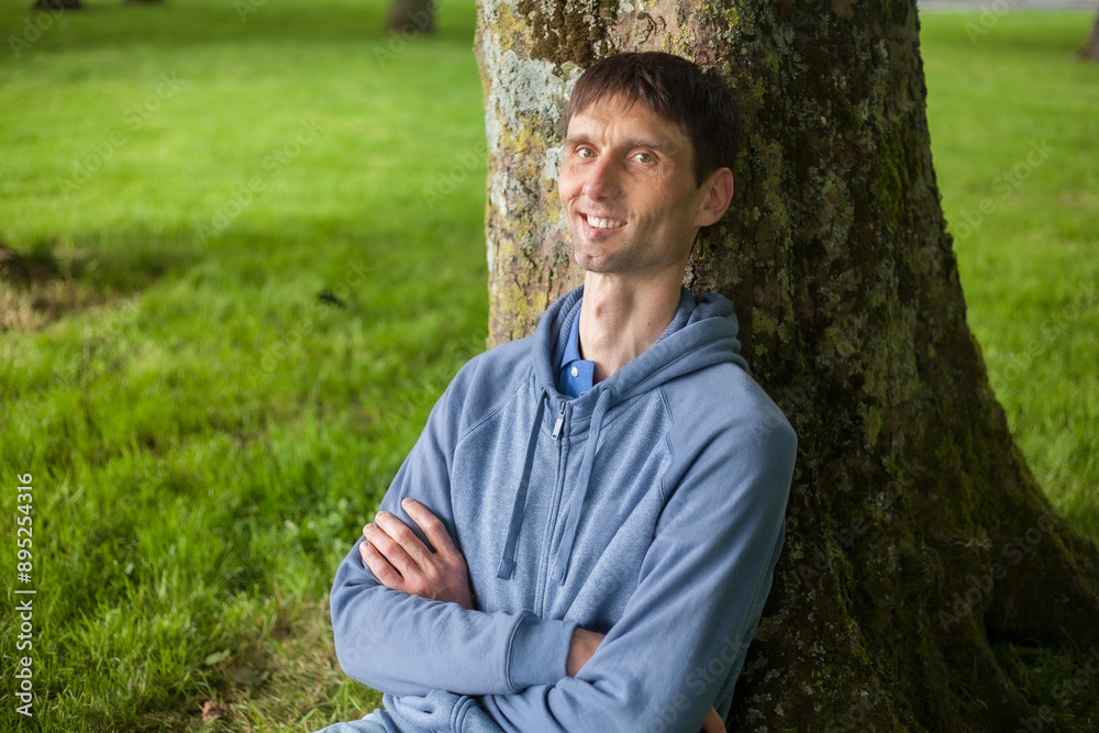 joyful cheerful middle-aged man in nature on a warm sunny day