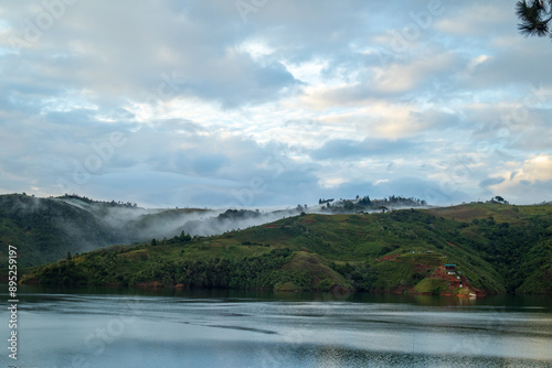 Fototapeta Naklejka Na Ścianę i Meble -  clouds flowing down the mountain in the lake 