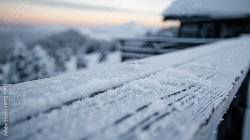 Wallpaper Mural A close-up shot of a snow-covered wooden railing with a scenic view of mountain terrain in the background, highlighting the serene beauty of a winter landscape. Torontodigital.ca