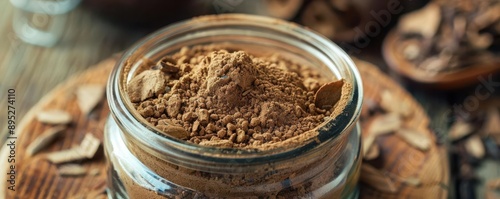Dried arjuna bark powder in a glass jar, traditional heart health herb