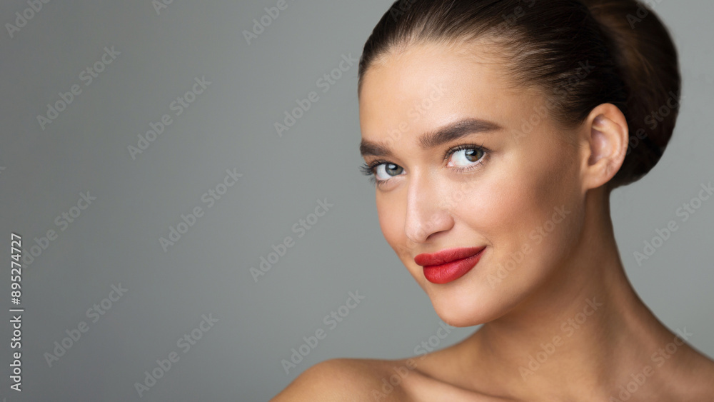 Beauty Model with Perfect Makeup and Red Lips Looking at Camera, Grey Background Beauty Model with Perfect Makeup and Red Lips Looking at Camera, Grey Background