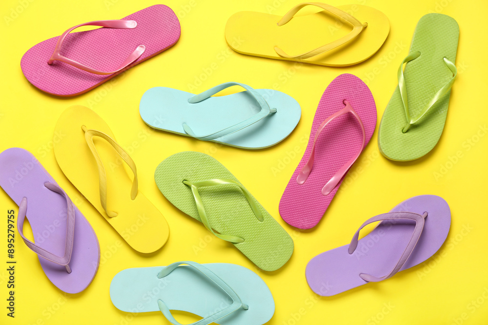 Colorful flip-flops on yellow background Colorful flip-flops on yellow background