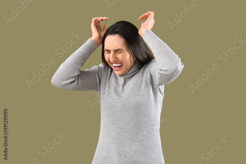 Scared young woman on color...