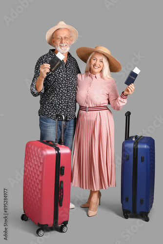Senior couple with suitcase...