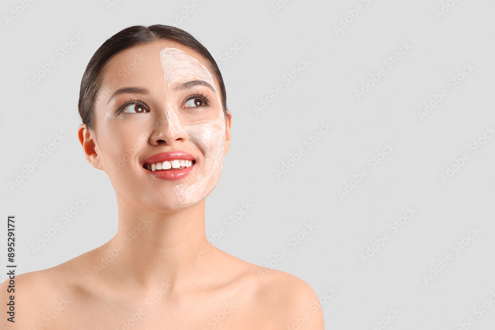 Young Asian woman with facial mask on light background, closeup Young Asian woman with facial mask on light background, closeup