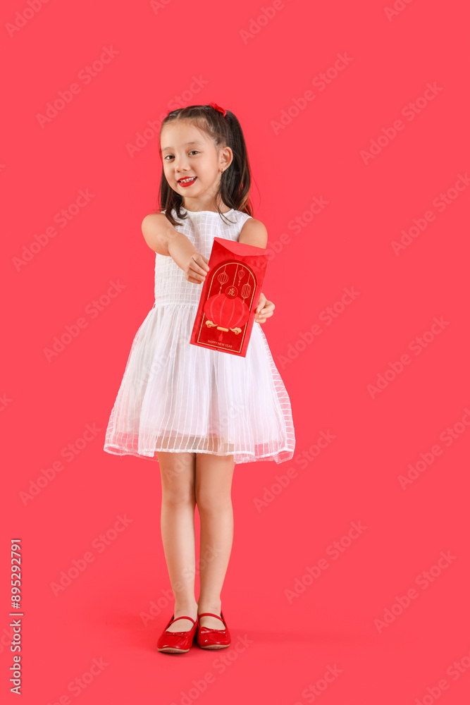 Cute little Asian girl with envelope on red background. Chinese New Year celebration Cute little Asian girl with envelope on red background. Chinese New Year celebration