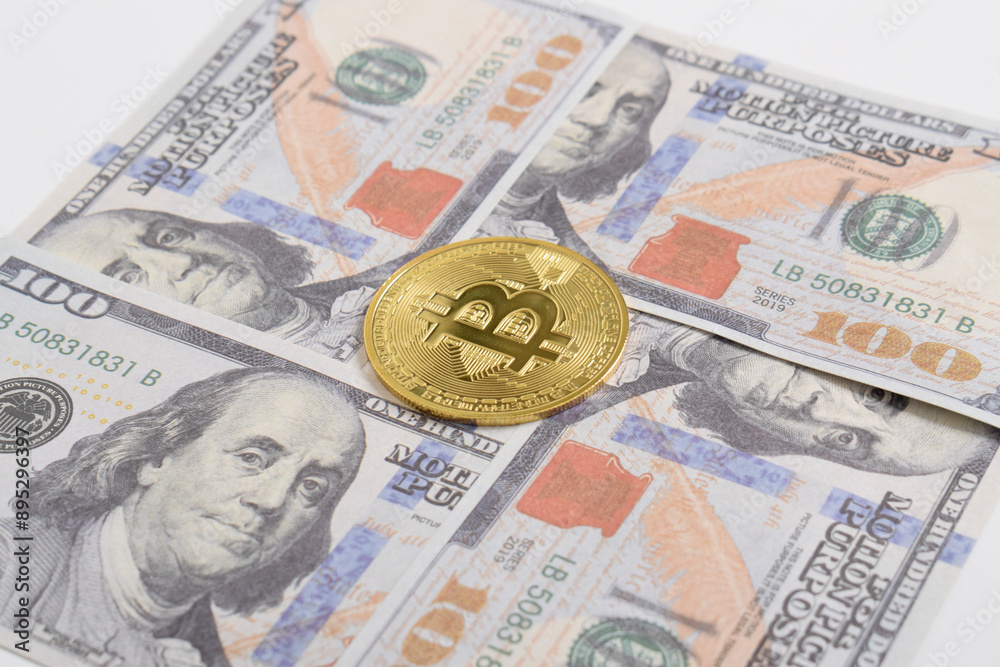 Golden symbolic coin Bitcoin on banknotes of one hundred dollars. Exchange bitcoin cash for a dollars. Cryptocurrency on US dollar bills. Savings, investments concept. Digital modern method of payment Golden symbolic coin Bitcoin on banknotes of one hundred dollars. Exchange bitcoin cash for a dollars. Cryptocurrency on US dollar bills. Savings, investments concept. Digital modern method of payment