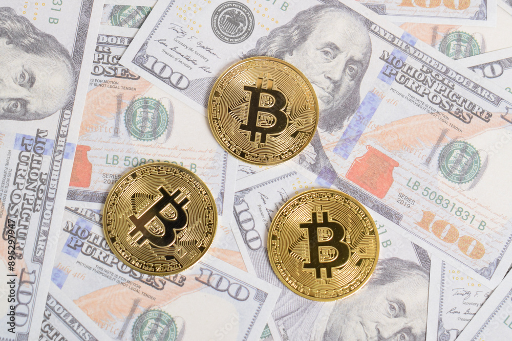 Golden symbolic coin Bitcoin on banknotes of one hundred dollars. Exchange bitcoin cash for a dollars. Cryptocurrency on US dollar bills. Savings, investments concept. Digital modern method of payment Golden symbolic coin Bitcoin on banknotes of one hundred dollars. Exchange bitcoin cash for a dollars. Cryptocurrency on US dollar bills. Savings, investments concept. Digital modern method of payment