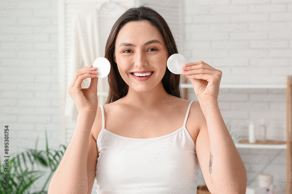 Happy young woman with cotton pads for removing makeup at home Happy young woman with cotton pads for removing makeup at home