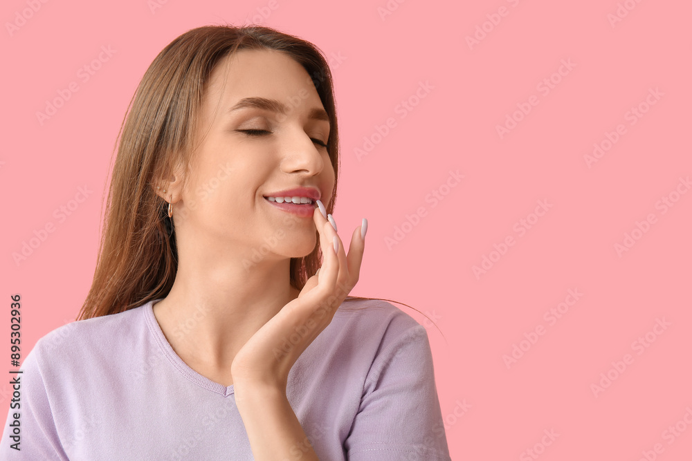 Beautiful young woman touching her lips on pink background Beautiful young woman touching her lips on pink background