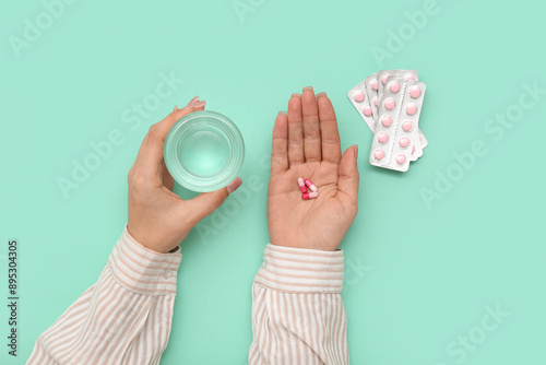 Woman's hands holding pills...
