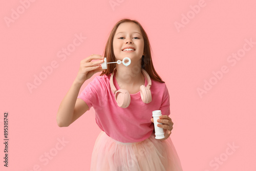 Happy girl blowing soap bub...