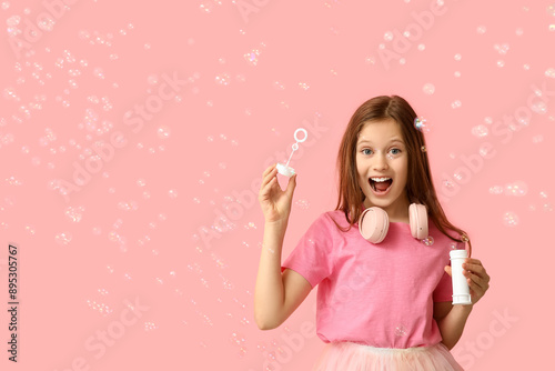 Happy girl blowing soap bub...