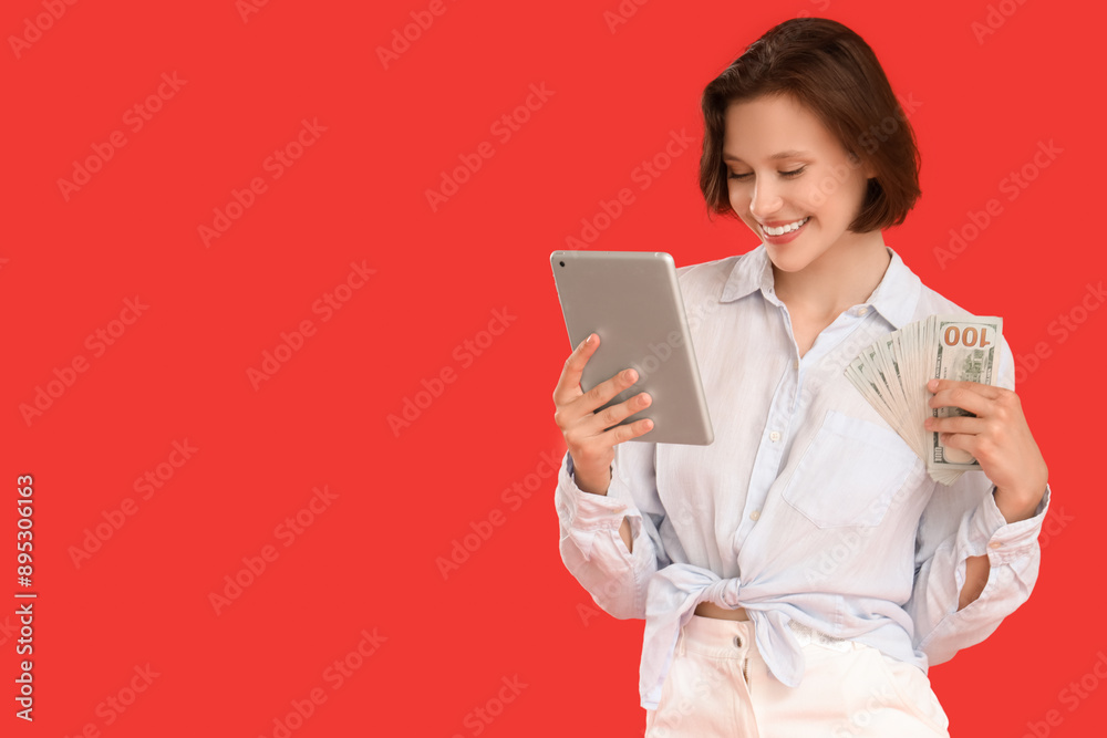 Happy young woman with money and tablet computer on red background Happy young woman with money and tablet computer on red background