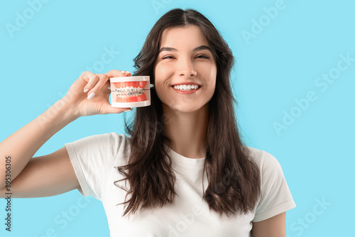 Smiling young woman holding...