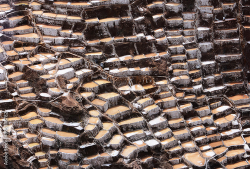 High angle view of terraced saltern on the hill with salt water at Salineras Salt Farm of Andes in summer, Cusco, Peru
 photo