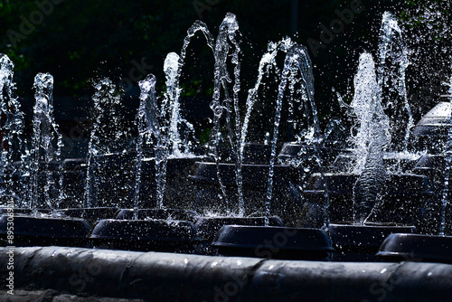 Yangsu-ri, Yangpyeong-gun, Gyeonggi-do, South Korea - July 4, 2020: Captured moments of fountain water sprouting from crock tops against black background at Semiwon lotus Museum
 photo