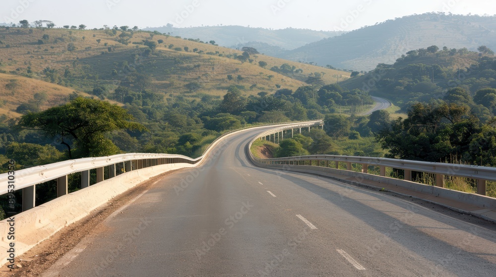 A beautiful curving road stretches through the rolling hills of the countryside, surrounded by lush green landscapes and distant hills under a clear sky, perfect for travel. A beautiful curving road stretches through the rolling hills of the countryside, surrounded by lush green landscapes and distant hills under a clear sky, perfect for travel.