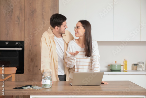 Young couple with laptop an...