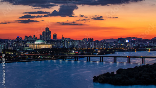 Yeouido, Yeongdeungpo-gu, Seoul, South Korea - September 26, 2018: Panoramic and sunset view of Sogang Bridge on Han River with National Assembly and apartments against red sky 