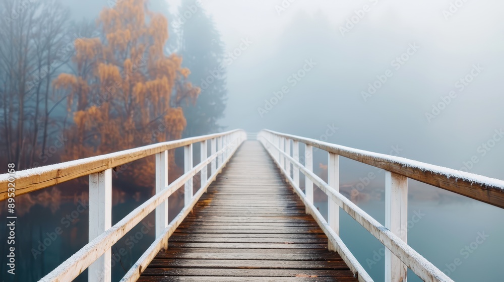 A mist-covered bridge leads through a foggy landscape flanked by autumn trees, creating a picturesque scene filled with seasonal charm and a sense of mystery. A mist-covered bridge leads through a foggy landscape flanked by autumn trees, creating a picturesque scene filled with seasonal charm and a sense of mystery.