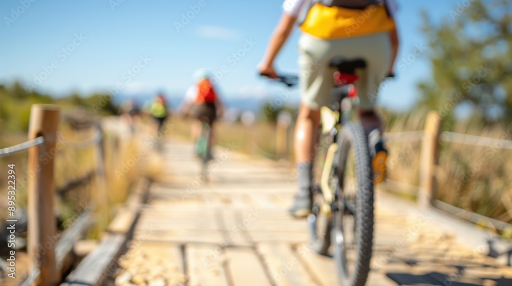 Naklejka premium An engaging image of bicyclists riding on a wooden trail during a bright, sunny day, highlighting the joy of outdoor activity, freedom, and the beauty of nature in full bloom.