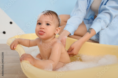 Cute little baby with mothe...